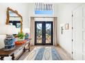 Bright entryway with elegant console table and statement mirror at 1023 Tocobaga Ln, Sarasota, FL 34236