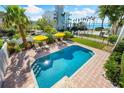 Refreshing pool with brick patio and lounge chairs at 1023 Tocobaga Ln, Sarasota, FL 34236