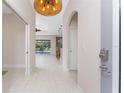 Foyer view showcases an arched doorway and seamless flow to the living area and lanai at 1069 Harbour Cape Pl, Punta Gorda, FL 33983