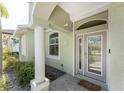 Close-up of a home's front door, showcasing its elegant design, sidelights, and welcoming entrance at 1069 Harbour Cape Pl, Punta Gorda, FL 33983