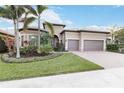 Spacious home exterior with a two-car garage and manicured lawn at 11101 Sandhill Preserve Dr, Sarasota, FL 34238