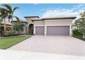 Beautiful home exterior with a two-car garage and landscaping at 11101 Sandhill Preserve Dr, Sarasota, FL 34238