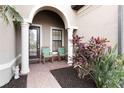 Inviting front porch with seating area and lush landscaping at 11101 Sandhill Preserve Dr, Sarasota, FL 34238