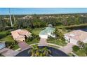 Aerial view of houses with a pond and green space in the background at 11458 Saffron Ct, Venice, FL 34292