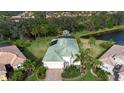 Aerial view of a house with solar panels and a lush green lawn at 11458 Saffron Ct, Venice, FL 34292