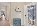 Inviting foyer featuring a decorative front door, mirror, and tiled floors at 11938 Tempest Harbor Loop, Venice, FL 34292