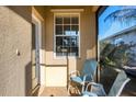 A cozy screened-in front porch with seating and a view at 11938 Tempest Harbor Loop, Venice, FL 34292