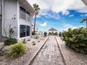 Brick pathway leads to beach; lush landscaping at 1336 Benjamin Franklin Dr # 1F, Sarasota, FL 34236