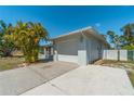 White garage door and long driveway at 134 Rotonda Cir, Rotonda West, FL 33947