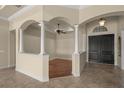 Inviting foyer with decorative columns, hardwood flooring, and a view of the formal dining area at 14208 Woodhall Pl, Bradenton, FL 34202