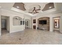 Expansive living area with a stone-accented entertainment wall and a built-in bar area at 14208 Woodhall Pl, Bradenton, FL 34202