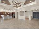 Open-concept living space with tile flooring, high ceilings, and seamless flow into the kitchen at 14208 Woodhall Pl, Bradenton, FL 34202