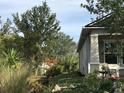 Landscaped side yard with mature trees and shrubs at 15079 Wichita Rd, Port Charlotte, FL 33981