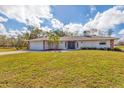 Charming single Gathering home with a well manicured lawn and double door entryway at 1573 Shadow Ridge Cir, Sarasota, FL 34240