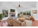 Bright living room with a stone fireplace and hardwood floors at 2037 Linwood Way, Sarasota, FL 34232