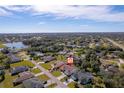 Aerial view showing home's location in a residential neighborhood near a lake at 207 Santarem Cir, Punta Gorda, FL 33983