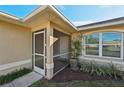 Screened-in front porch with access to the front door at 2551 Morrietta Ln, North Port, FL 34286
