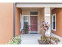 Townhome entry with a brown door and potted plants at 284 Crew Ct, Sarasota, FL 34243