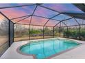 Screened-in pool offers a refreshing oasis with views of the surrounding natural landscape at 2926 Sultan Ct, North Port, FL 34286