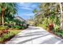 Long driveway leading to a beautiful home with tropical landscaping at 3142 Dick Wilson Dr, Sarasota, FL 34240