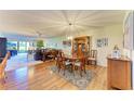 Bright dining room with hardwood floors and wooden furniture at 3500 El Conquistador Pkwy # 119, Bradenton, FL 34210