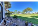 Relaxing patio overlooking a lush green golf course at 3500 El Conquistador Pkwy # 119, Bradenton, FL 34210