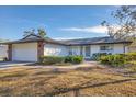 White single-story house with attached garage, walkway, and manicured lawn at 3762 San Luis Dr, Sarasota, FL 34235