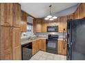 Cozy kitchen with dark wood cabinets, black appliances, and a granite countertop at 3815 42Nd W Ave, Bradenton, FL 34205