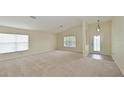 Bright living room featuring neutral walls and carpet at 3911 Douglas Hill Pl, Parrish, FL 34219