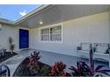 Front entrance with blue door, tile flooring, and comfortable seating at 3950 Sawyerwood Rd, Sarasota, FL 34233