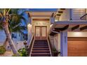 Inviting entryway with double doors and a charming wooden staircase at 421 Pine Ave, Anna Maria, FL 34216