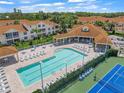 Community pool, tennis courts, and clubhouse at 4215 Breezeway Blvd # 2420, Sarasota, FL 34238