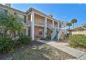 Charming condo with white railings, stairs and nicely landscaped garden beds in a well-maintained community at 4705 Sand Trap Street E Cir # 105, Bradenton, FL 34203