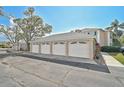 Row of garages with white doors in a well-maintained community at 4705 Sand Trap Street E Cir # 105, Bradenton, FL 34203