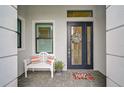 Inviting entryway with a white bench and a modern door at 4940 Surfside Cir, Bradenton, FL 34211