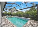 Relaxing pool area with covered patio and lush landscaping at 4940 Surfside Cir, Bradenton, FL 34211