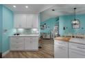 White shaker cabinets, quartz countertops, and mosaic backsplash in this kitchen at 5424 81St Avenue E Cir, Palmetto, FL 34221