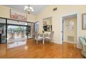 Bright dining area with hardwood floors and access to a screened balcony at 6084 Red Maple Rd, Bradenton, FL 34210