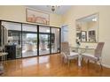 Bright dining area with hardwood floors and access to a screened balcony at 6084 Red Maple Rd, Bradenton, FL 34210