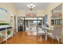 Bright dining area with hardwood floors and access to a screened balcony at 6084 Red Maple Rd, Bradenton, FL 34210