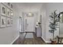 Bright entryway with wood-look floors and gallery wall at 6428 Devesta Loop, Palmetto, FL 34221