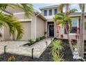 Front entry with walkway, landscaping, and blue door at 6428 Devesta Loop, Palmetto, FL 34221