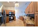 Granite countertops, stainless steel appliances, and light wood cabinets in a spacious kitchen at 6589 Fairway Gardens Dr, Bradenton, FL 34203