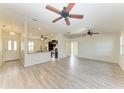 Open living room and kitchen with hardwood floors at 7930 Verna Bethany Rd, Myakka City, FL 34251