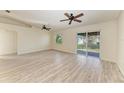 Spacious living room with hardwood floors and ceiling fans at 7930 Verna Bethany Rd, Myakka City, FL 34251