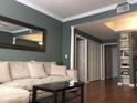 Living room with beige couch and hardwood floors at 800 S Dakota Ave # 329, Tampa, FL 33606