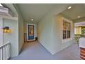 Inviting covered front porch with a blue entry door and a 'Welcome' mat, creating a warm ambiance at 8030 Hampton Lake Dr, Tampa, FL 33647