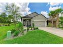 Single-story home with a two-car garage and nicely landscaped front yard at 8250 Velda Trl, Sarasota, FL 34241