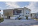 Exterior of a move-in ready manufactured home with covered carport at 10315 Cortez W Rd # 5H, Bradenton, FL 34210