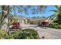 One-story house featuring a paver driveway and lush landscaping at 12471 Natureview Cir, Bradenton, FL 34212